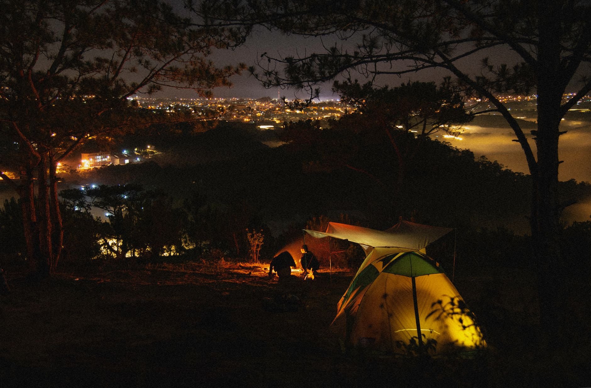Rechargeable LED camp lantern illuminating a hunting camp at night