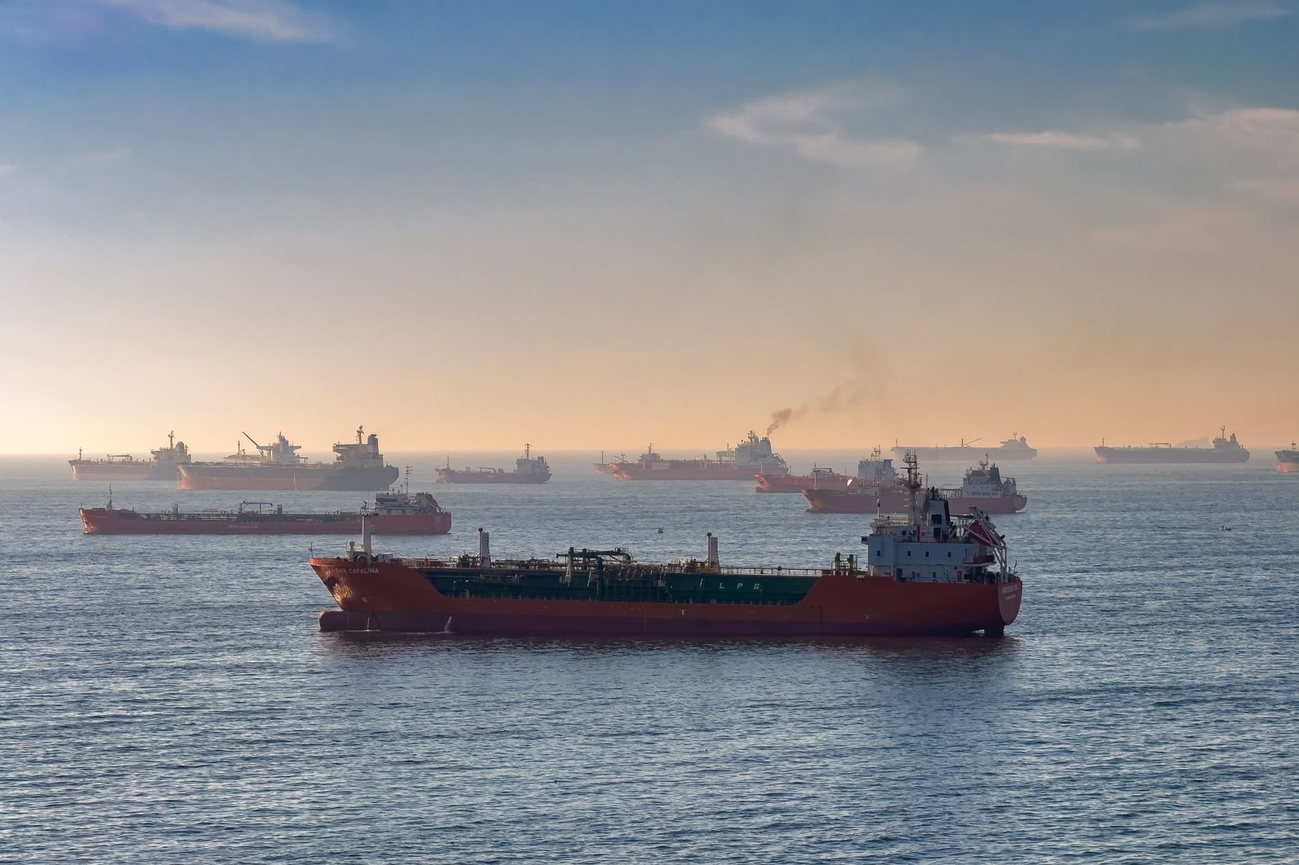 Cargo ships and oil tankers on the Bosporus strait at sunset.