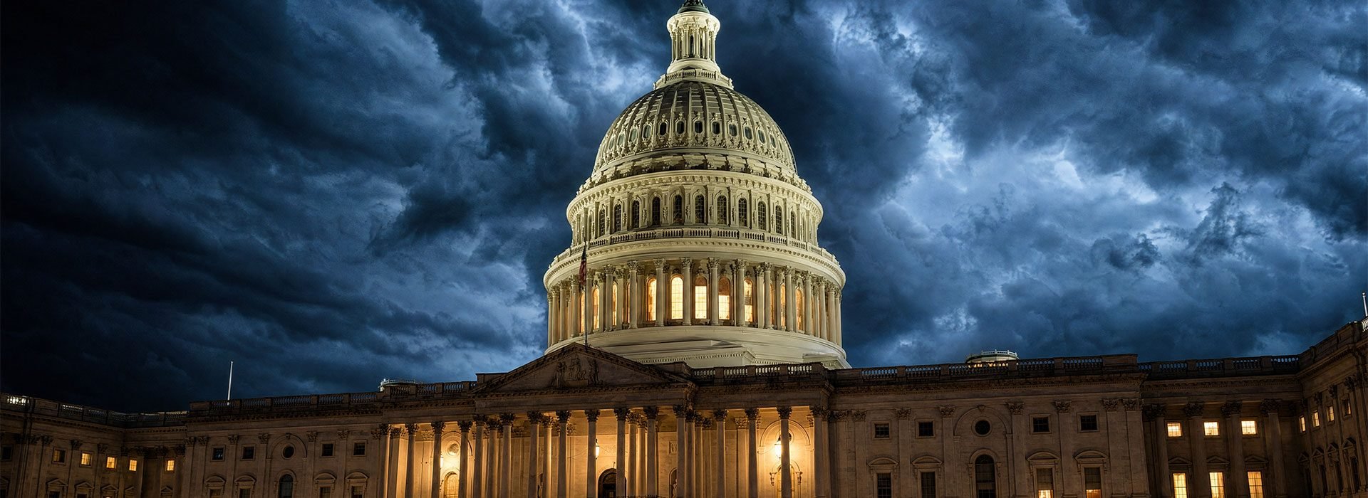 US Capitol building at night under stormy dramatic clouds