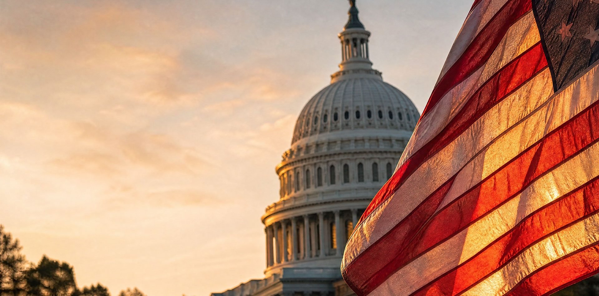 US Capitol building at sunset with American flag in foreground
