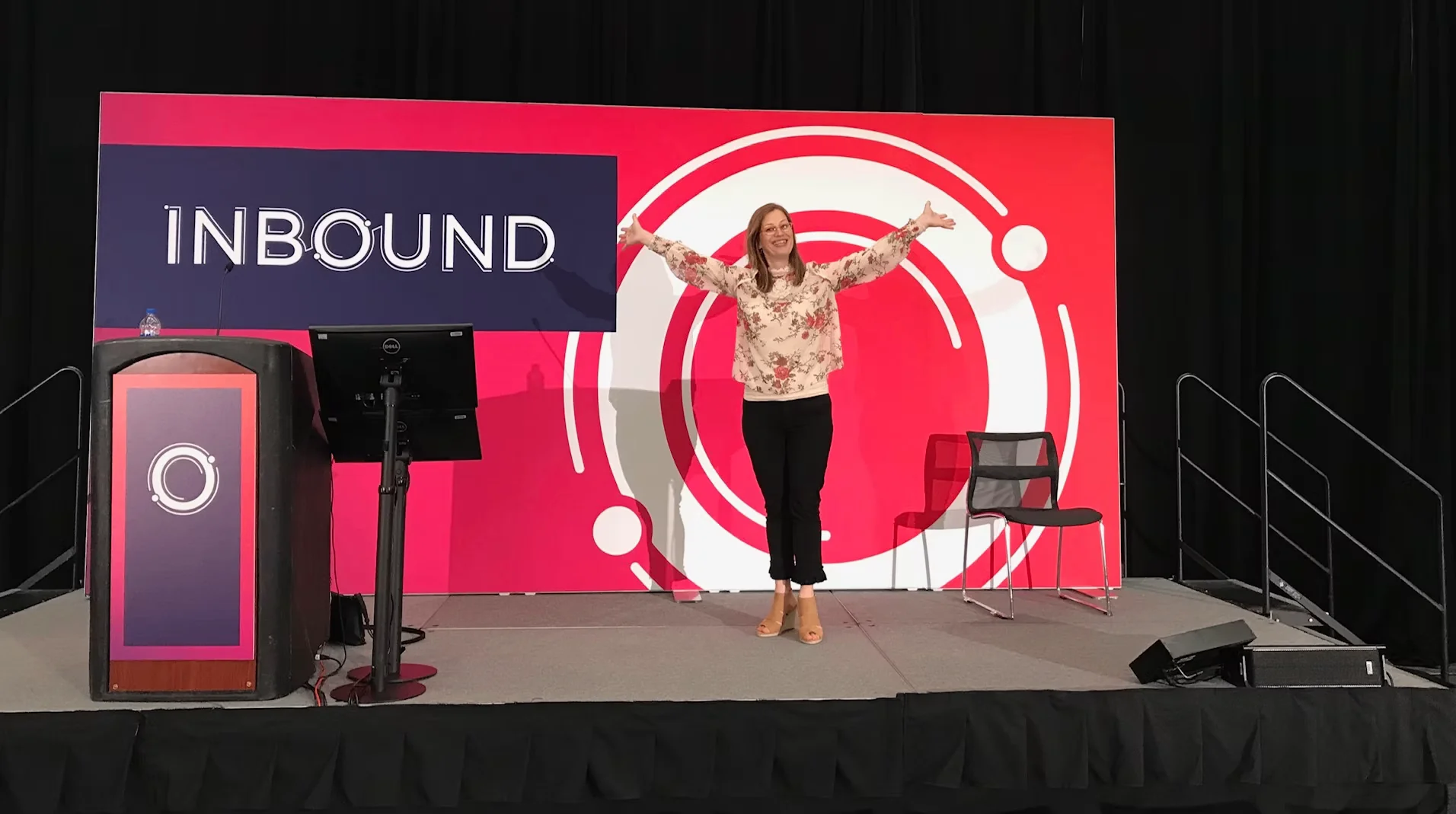 Dorien speaking on stage at INBOUND conference with arms raised