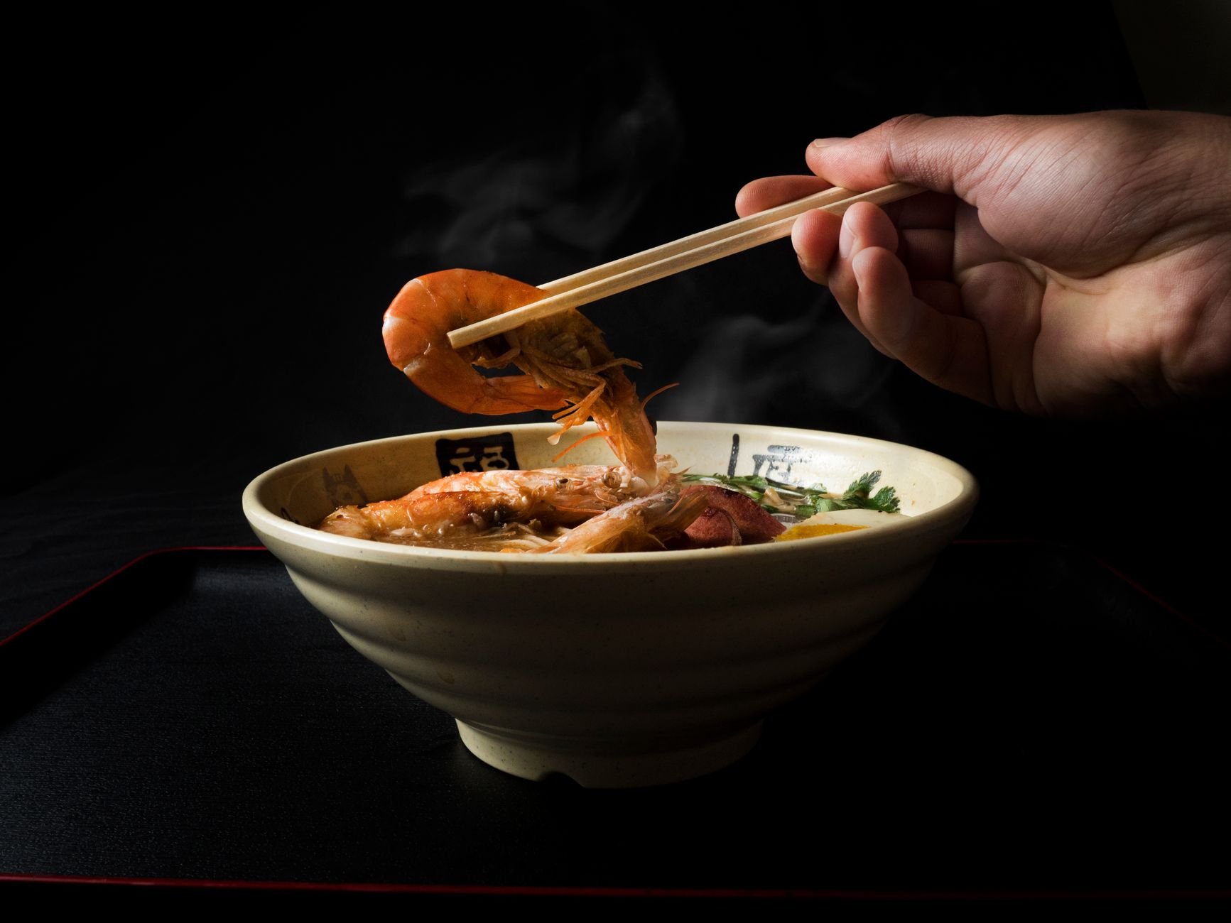 Steaming bowl of ramen with chopsticks