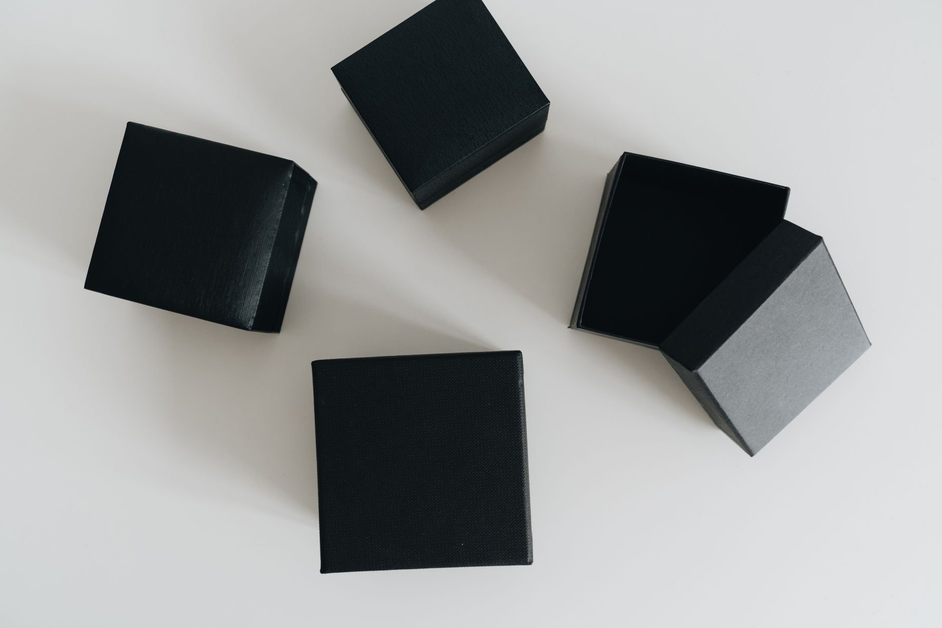 An open Founder's Shelf subscription box with a curated book, Shelf Notes, annotation tools, and collectible stickers inside black tissue paper with a red tape strip.