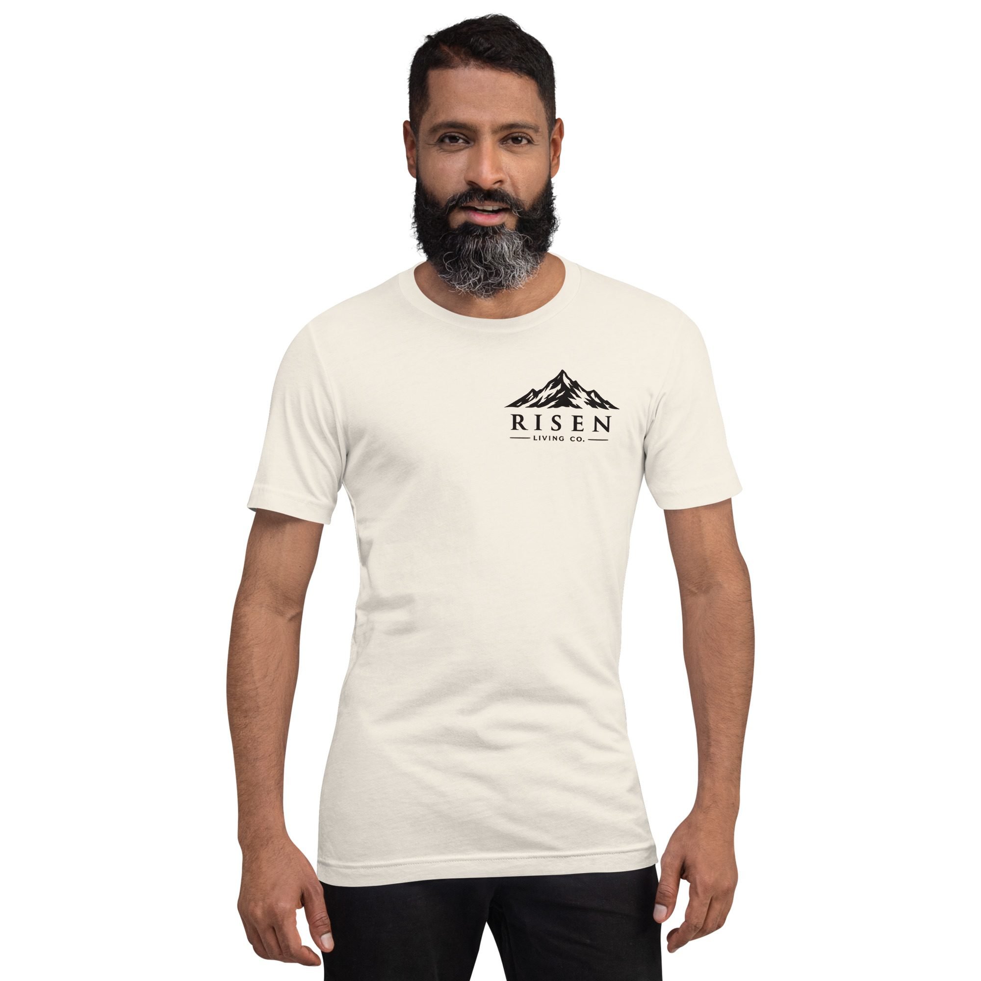 Man wearing Risen Living Co. mountain wordmark tee in vintage white, clean background