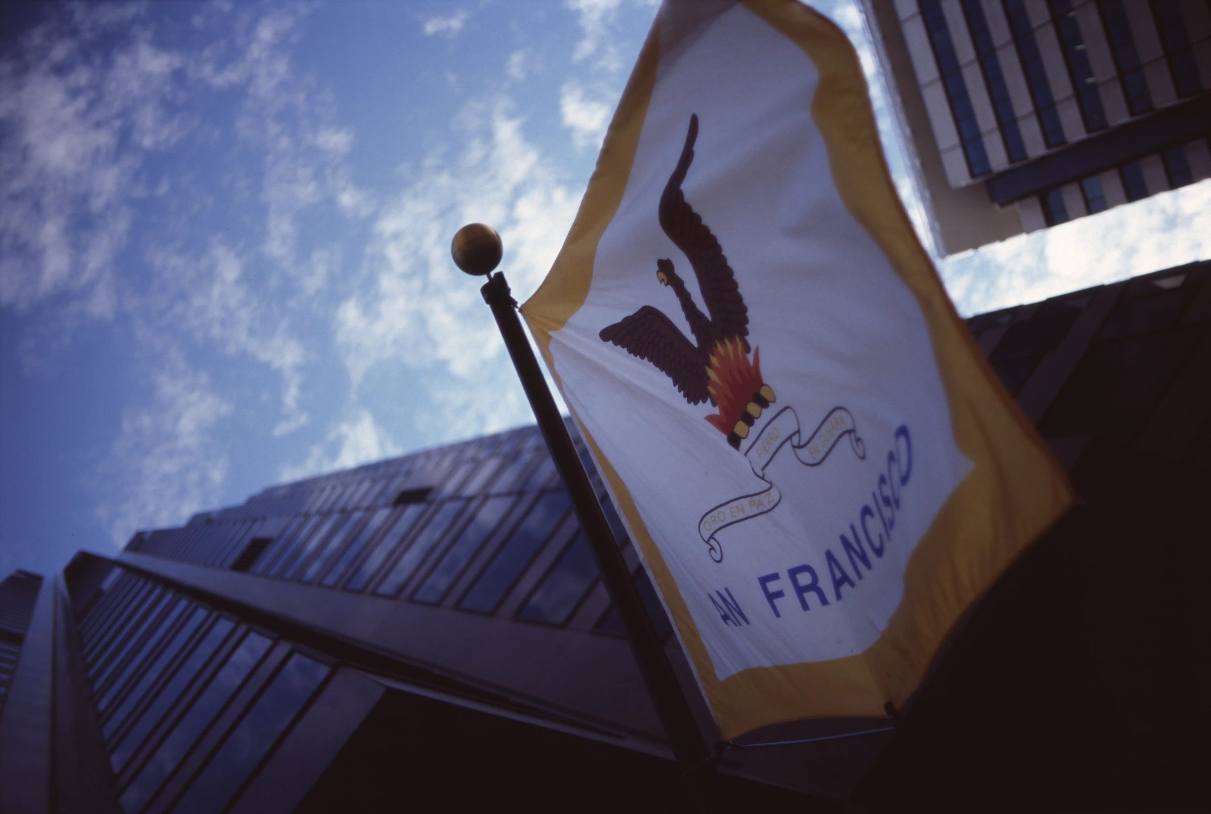 San Francisco city flag shot from below against a blue sky, film photograph