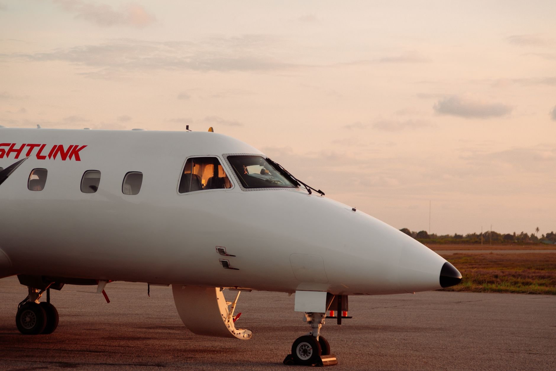 Sleek private jet on runway at golden sunset