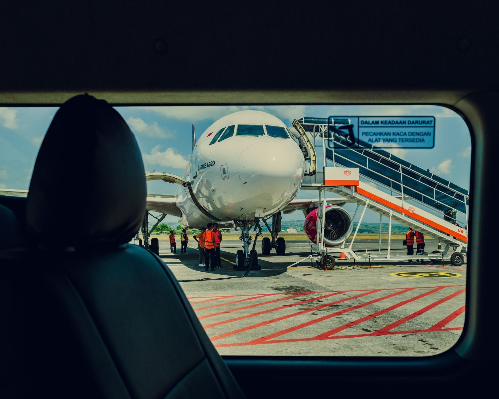 Airport ground crew and aircraft on the tarmac — the real-world environment Skylearn trains for.