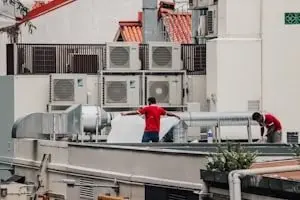 Rooftop HVAC units with technicians