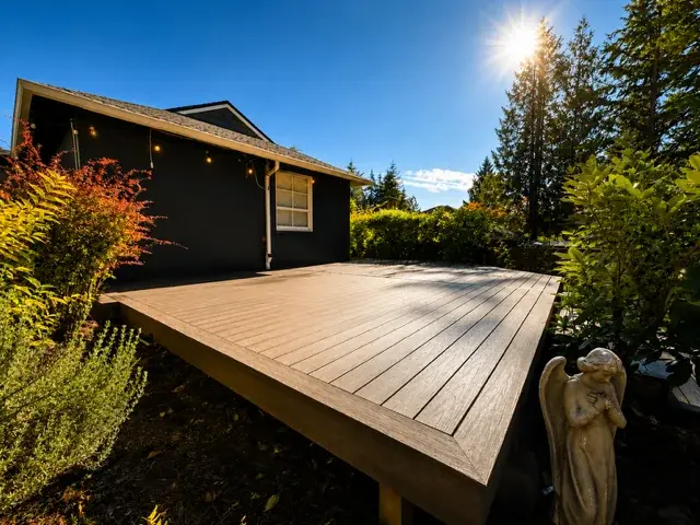 Floating composite deck with angel statue and lush Pacific Northwest garden landscaping