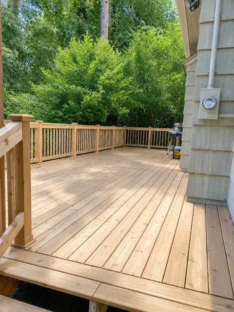 Fresh cedar deck with railing overlooking a lush green Pacific Northwest backyard
