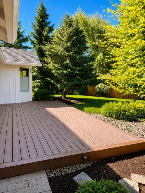 Floating composite deck with warm brown tones surrounded by Pacific Northwest landscaping