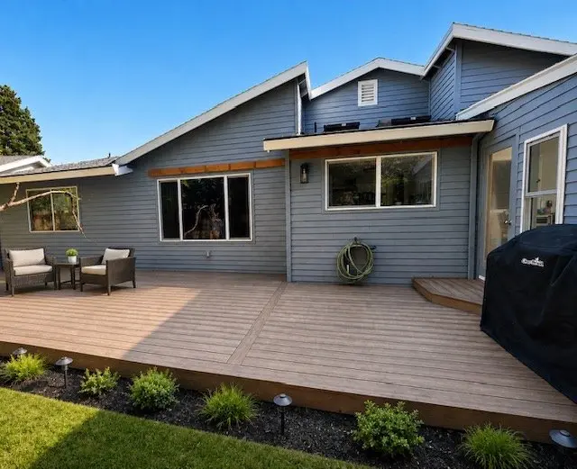 Composite deck with outdoor seating area and lush landscaping — PDX Home Revival